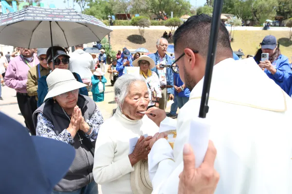 Several faithful come forward to receive the Eucharist. Credit: Eduardo Berdejo / EWTN News.