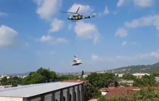 Un helicóptero de las fuerzas armadas retira el helicóptero de la policía que cayó sobre la Iglesia de La Merced. Crédito: PNC El Salvador 