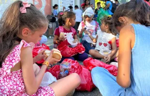 Niñas comiendo en la Fiesta Nacional de Navidad en Costa Rica. Crédito: Asociación Obras del Espíritu Santo