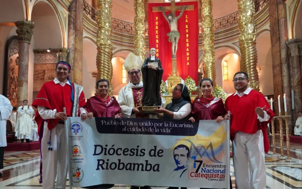 Mons. Marcos Pérez, Archbishop of Cuenca, receives an image of the Holy Brother Miguel Febres Cordero during the opening mass of the event. Credit: Radio Católica Cuenca.