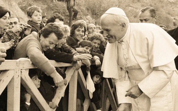 Saint John Paul II seeking to cheer up a child (image with photographic filter). Credit: Vatican Media - EWTN