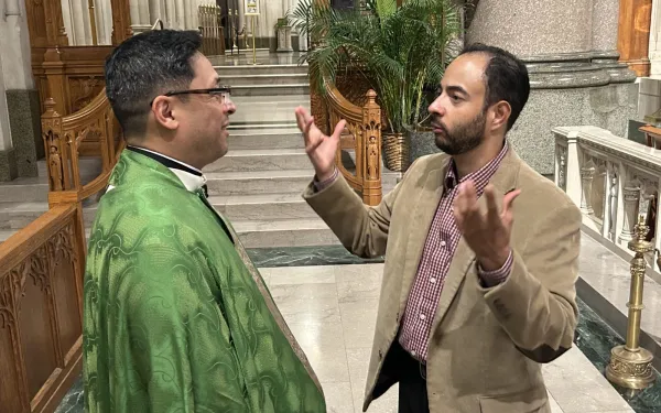 Father Bismarck Chau, rector of the Cathedral-Basilica of the Sacred Heart in Newark, speaks with photographer Andrew Masi.  Credit: Sean Quinn/Archdiocese of Newark.