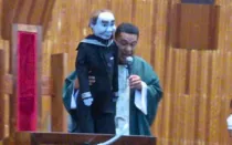 El P. Víctor Hugo Rea en Misa con el muñeco polémico.
