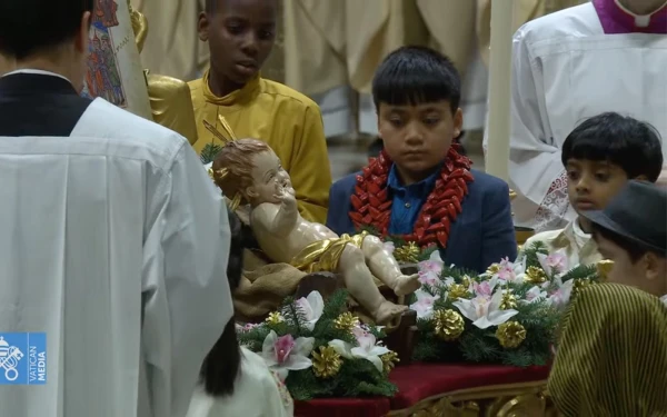 Children of different nationalities place flowers around the Baby Jesus in St. Peter's Basilica, on Christmas Eve 2024. Credit: Video capture / Vatican Media.