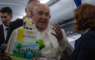 El Papa Francisco recibe una tarta de cumpleaños durante el vuelo de regreso de Córcega el 15 de diciembre Crédito: Daniel Ibáñez/EWTN News