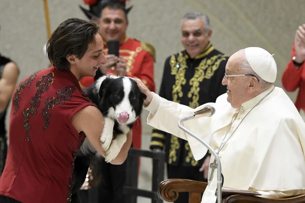 The Pope caresses a dog during the circus show at the General Audience. Credit: Vatican Media