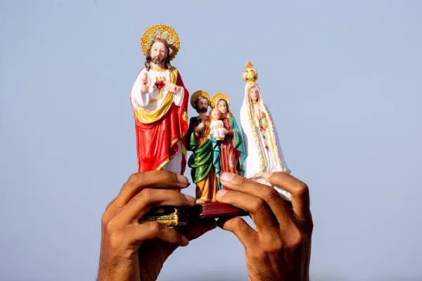 A faithful raises religious images during the Pope's Mass. Credit: Daniel Ibáñez/ EWTN News