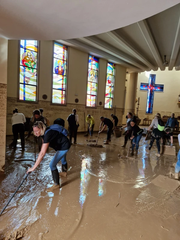 Volunteers shrink the water of the church. Credit: courtesy